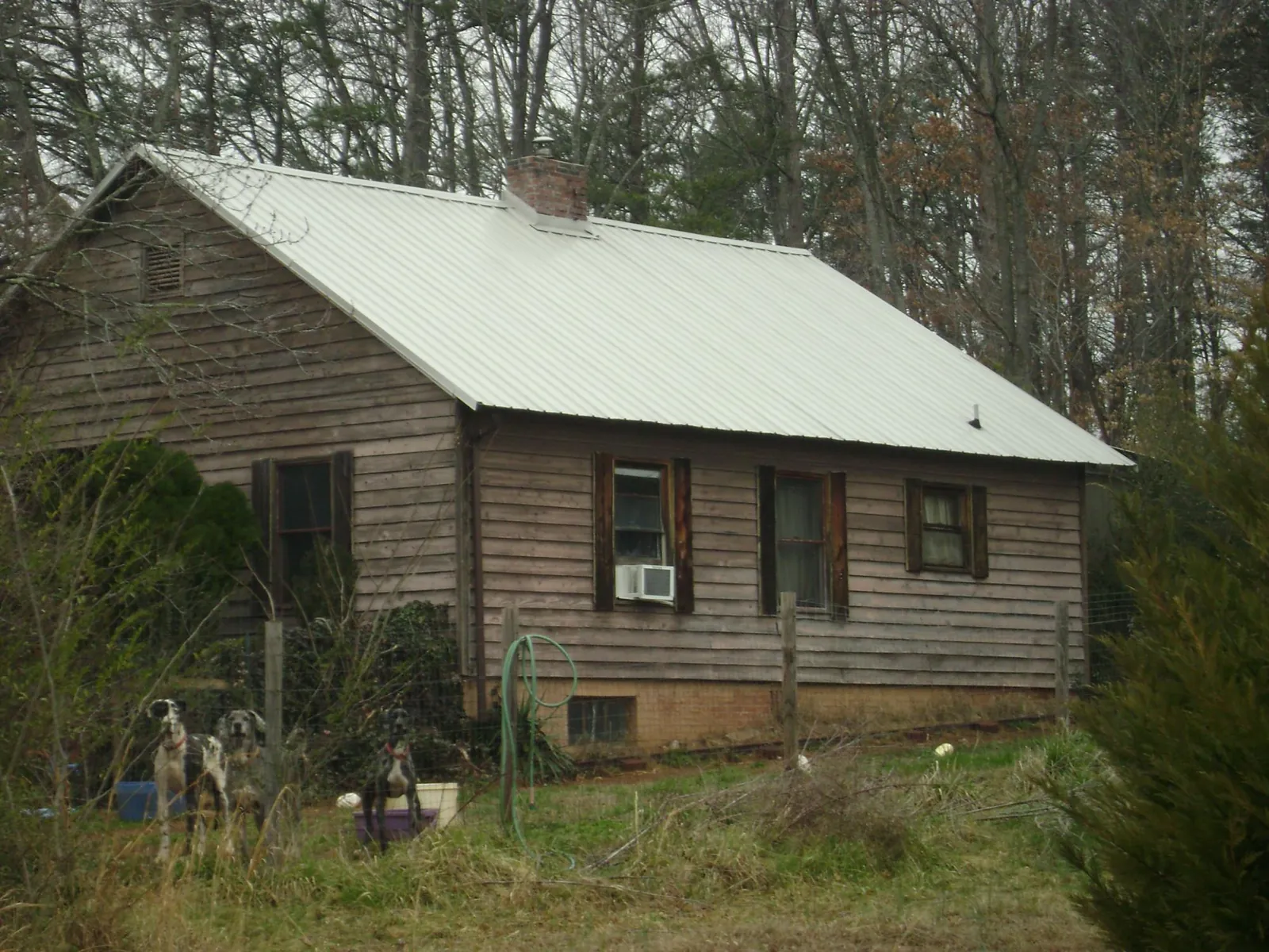 White metal roof on an old wood sided farmhouse, from a Metal Roof Installation job in Moscow